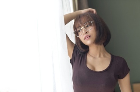 Pretty Asian teen flaunts her hot ass wearing a miniskirt and panties