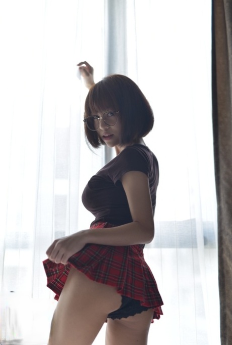 Pretty Asian teen flaunts her hot ass wearing a miniskirt and panties