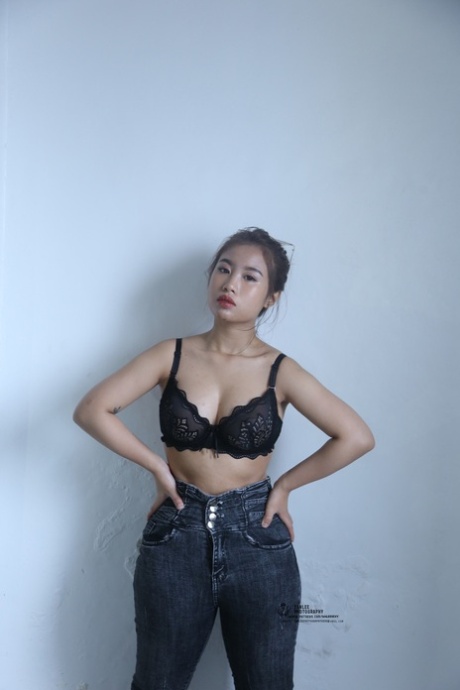 Kinky Asian honey poses completely nude and teases with her big tits and ass