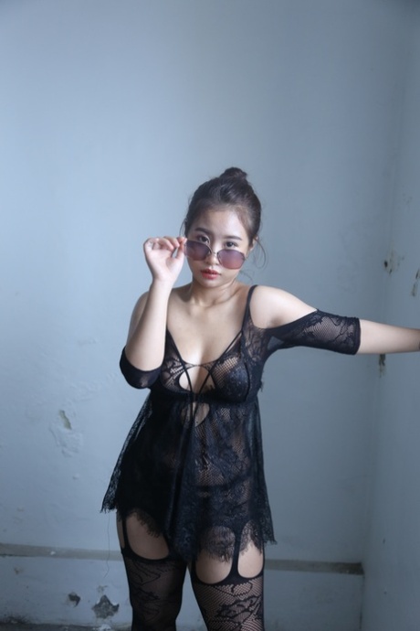 Kinky Asian honey poses completely nude and teases with her big tits and ass