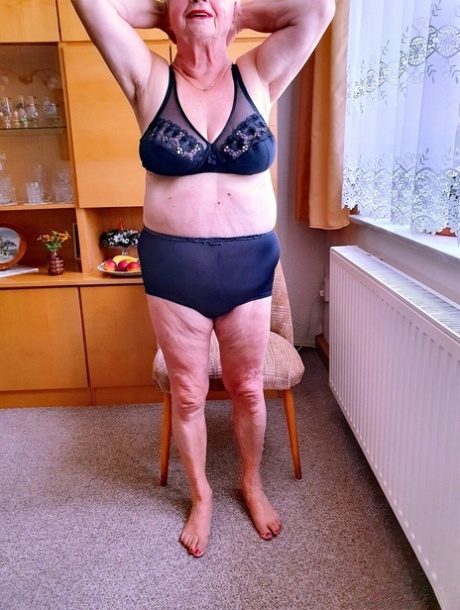 Short-haired granny Alma exposes her big saggy tits while changing