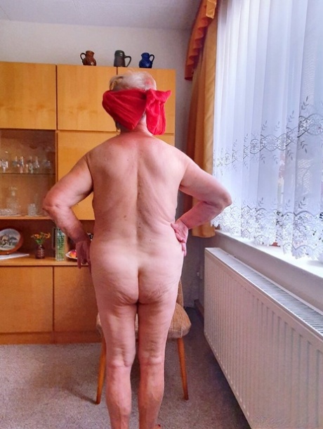 Short-haired granny Alma exposes her big saggy tits while changing