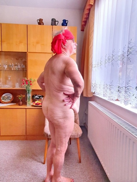 Short-haired granny Alma exposes her big saggy tits while changing