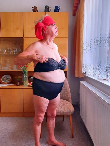 Short-haired granny Alma exposes her big saggy tits while changing