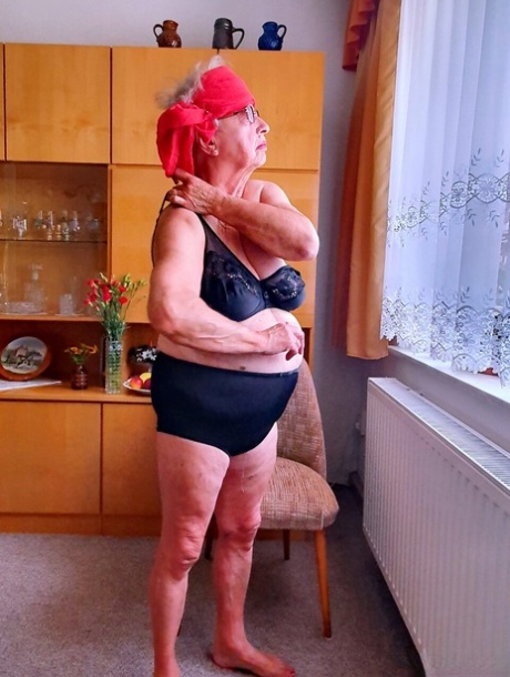 Short-haired granny Alma exposes her big saggy tits while changing