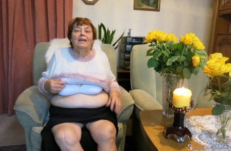 Tall redheaded granny Kurra loses her white lingerie and shows her saggy tits
