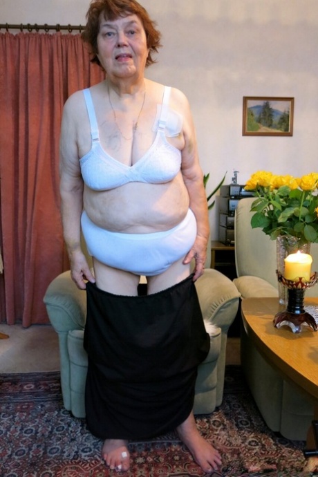 Tall redheaded granny Kurra loses her white lingerie and shows her saggy tits