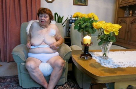 Tall redheaded granny Kurra loses her white lingerie and shows her saggy tits