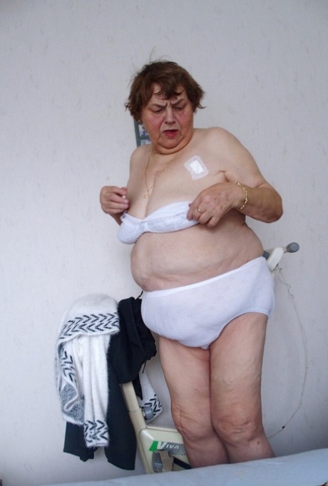 Tall redheaded granny Kurra loses her white lingerie and shows her saggy tits