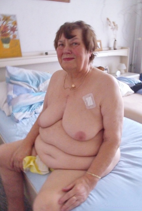 Tall redheaded granny Kurra loses her white lingerie and shows her saggy tits