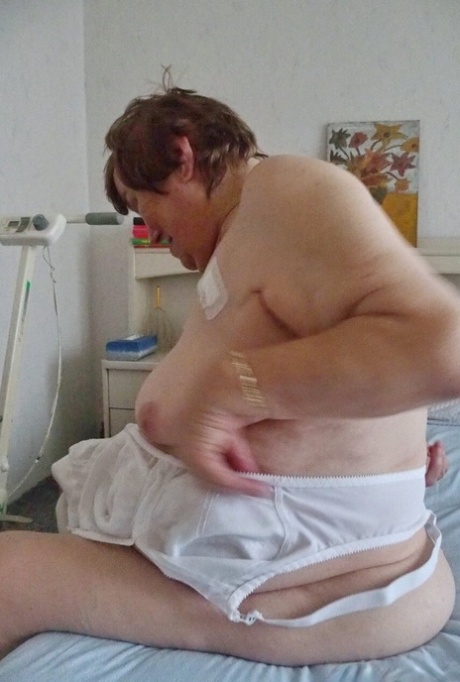 Tall redheaded granny Kurra loses her white lingerie and shows her saggy tits