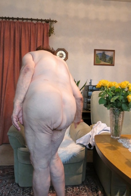 Naughty granny Kurra strips completely naked & shows off her saggy tits