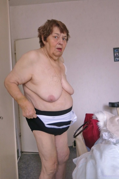 Naughty granny Kurra strips completely naked & shows off her saggy tits