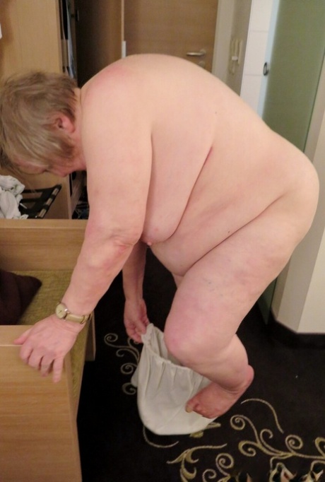 Fat granny Putarana washes her saggy tits before taking a bottle up her cunt