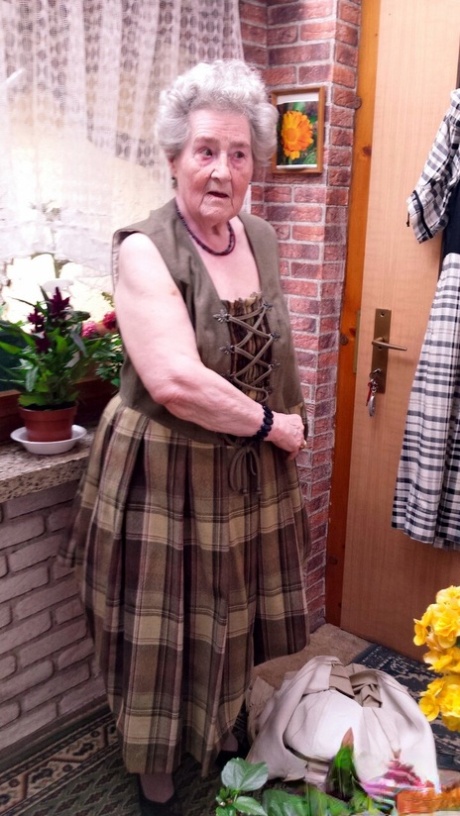 Short-haired granny Pitschka undressing and showing her saggy boobs