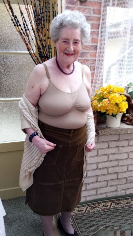 Short-haired granny Pitschka undressing and showing her saggy boobs