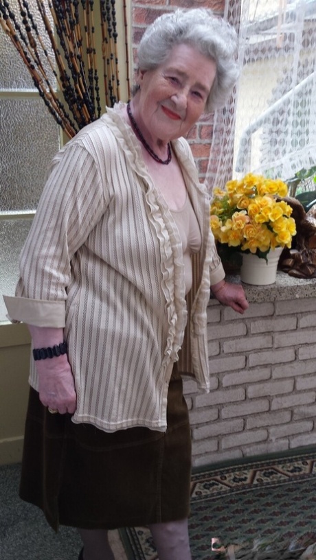 Short-haired granny Pitschka undressing and showing her saggy boobs