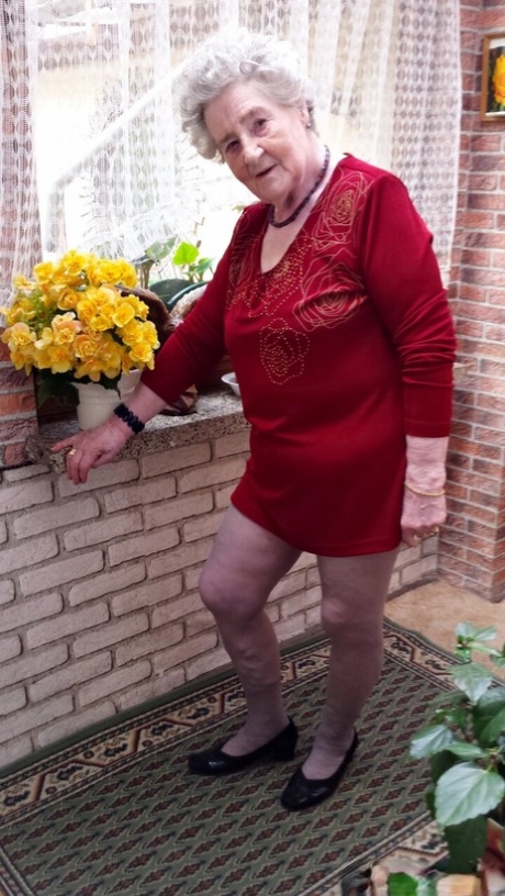Short-haired granny Pitschka undressing and showing her saggy boobs