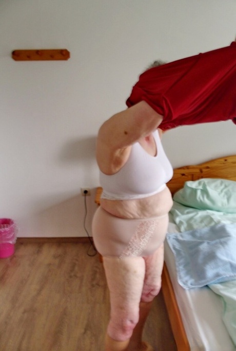 Short-haired granny Pitschka undressing and showing her saggy boobs