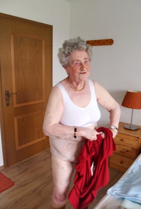 Short-haired granny Pitschka undressing and showing her saggy boobs