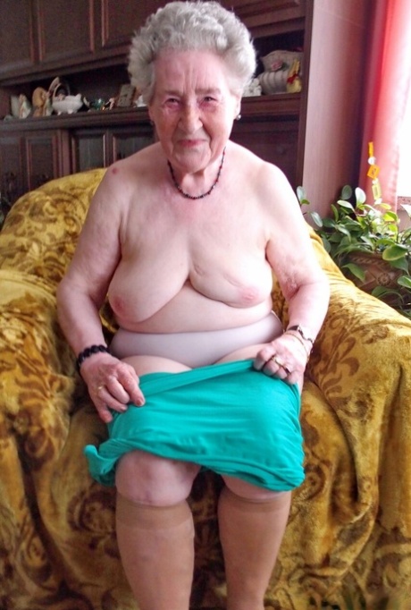 Short-haired granny Pitschka undressing and showing her saggy boobs