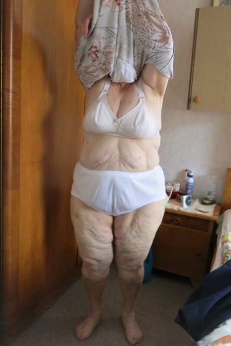 Short-haired granny Advotia displays her saggy tits in her solo compilation