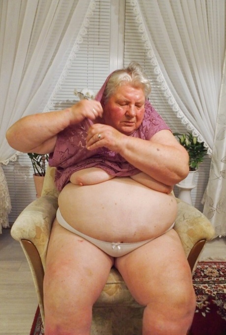 Fat granny Clotilde unveils her saggy tits and sucks a sex toy in a solo