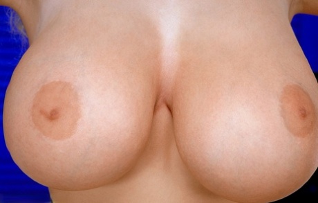 Slutty German MILF Julia Miles revealing & licking her enormous natural tits