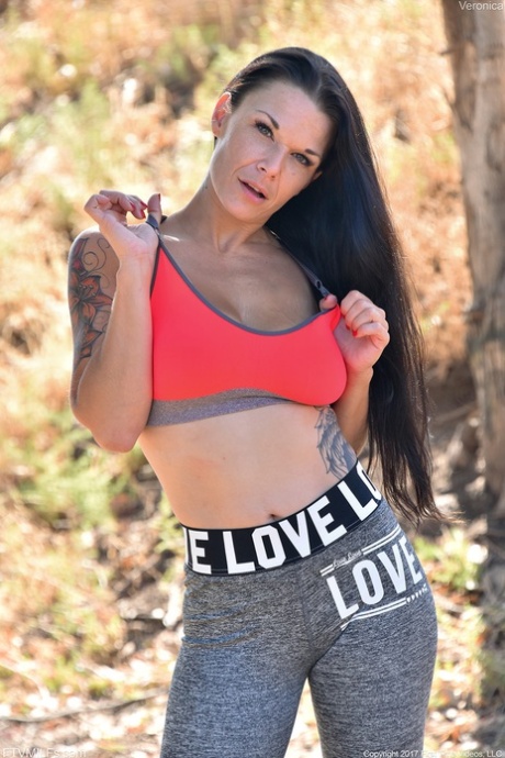 Brunette mature in yoga pants Veronica unveils her amazing big tits outdoors