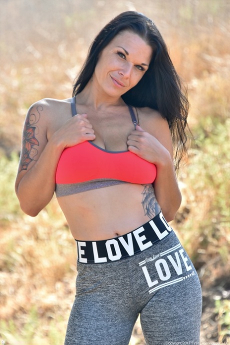 Brunette mature in yoga pants Veronica unveils her amazing big tits outdoors